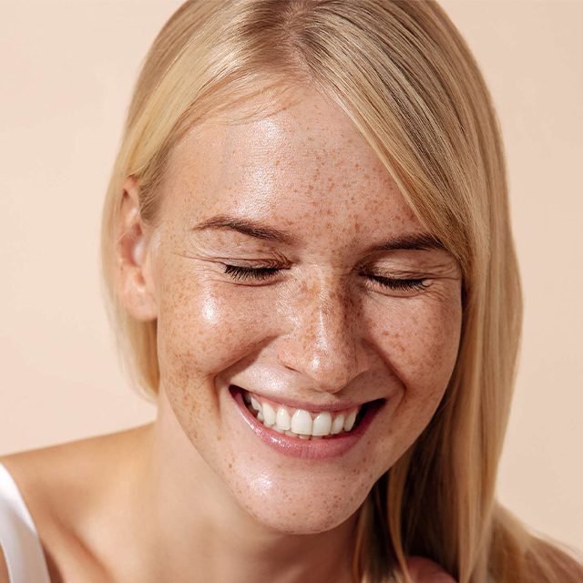 smiling woman with clear glowing skin