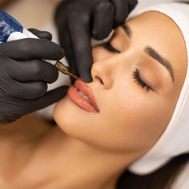 woman having a permanent makeup lip liner procedure