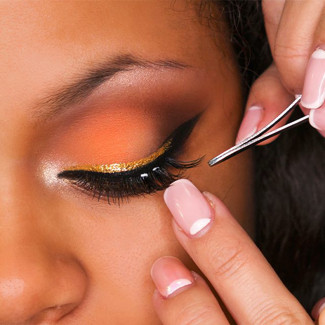 woman having false lashes applied professionally
